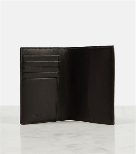 Cassandre leather passport holder in black .